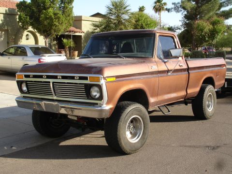 1977 Ford F-150 - This 1977 Ford F-150 pickup truck is shown from a 3/4 front perspective, highlighting its grille and overall condition.