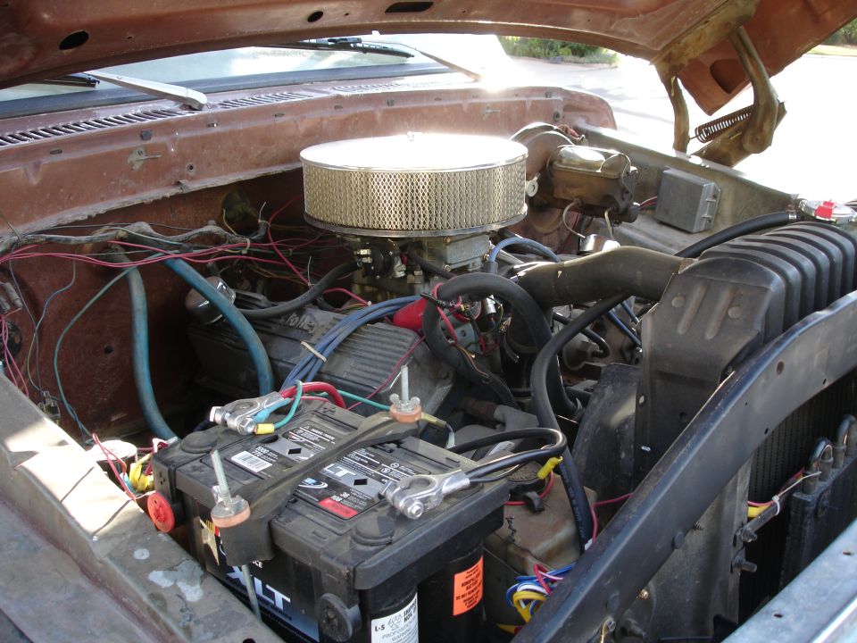 Brown 1977 Ford F-150 engine bay with dual batteries and aftermarket air filter