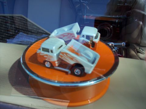 1972 Ford Ranchero - Toy trucks with flame decals are displayed on a rotating stand.