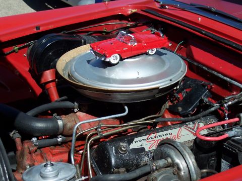 1972 Ford Ranchero - A red toy car sits atop the air cleaner of a vehicle's engine bay.