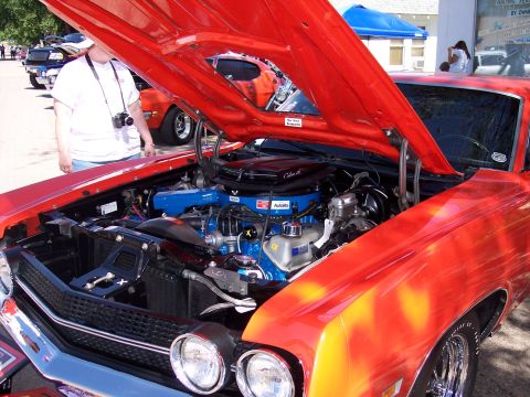 1972 Ford Ranchero - A red 1970s pickup truck is displayed with its hood open, revealing a detailed engine compartment.