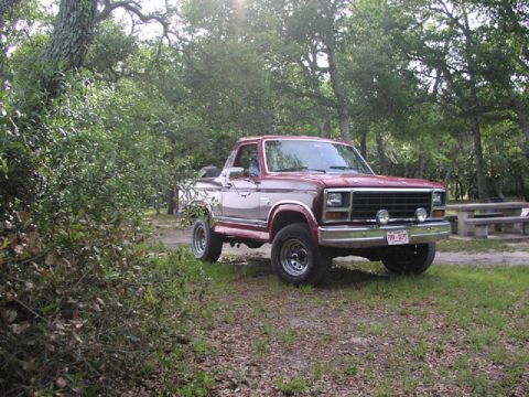 1981 Ford Bronco - This 1981 Ford Bronco is shown in a three-quarter front view, parked outdoors amongst trees.