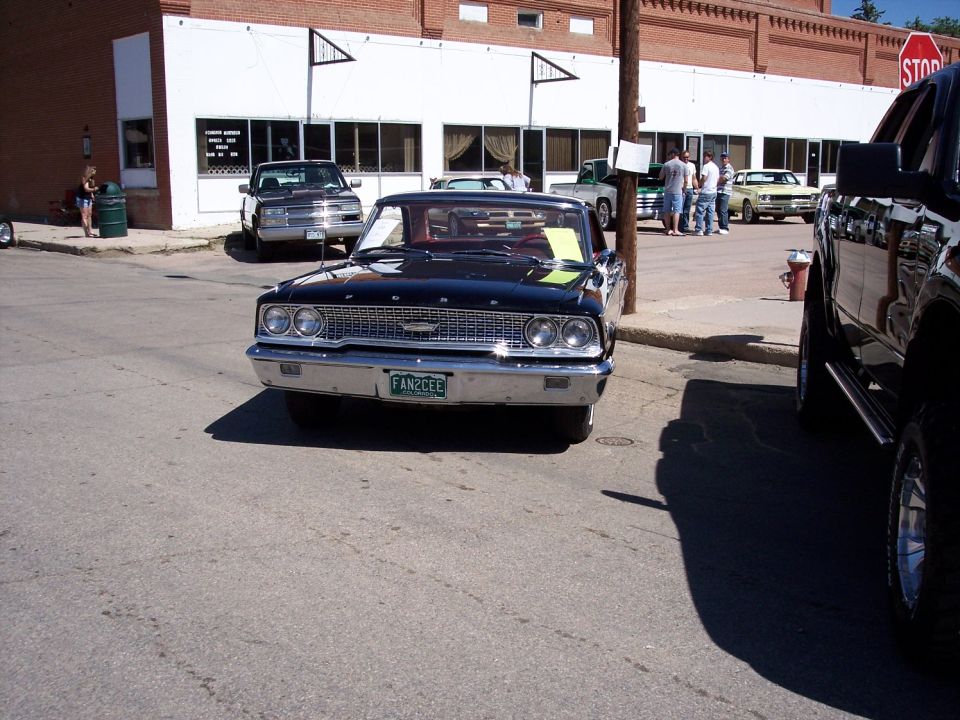 Black 1963 Ford Galaxie 500 front view with green license plate reading FAN2CEE