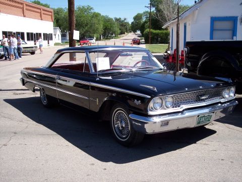 1972 Ford Ranchero - A classic black Ford Galaxie is parked on a street, with a red interior and a license plate from Colorado.