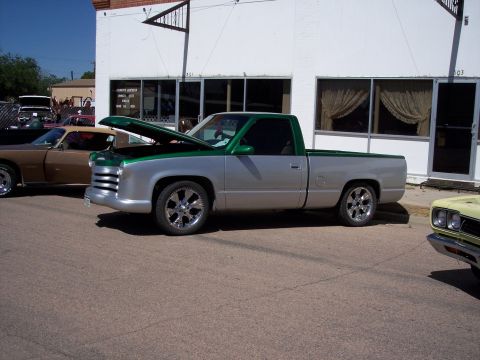 1972 Ford Ranchero - A modified pickup truck is displayed at a car show, with its hood up.
