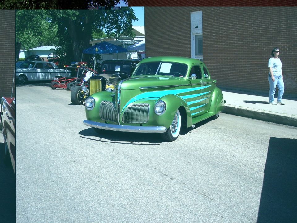 Green hot rod with teal stripes, front 3/4 view