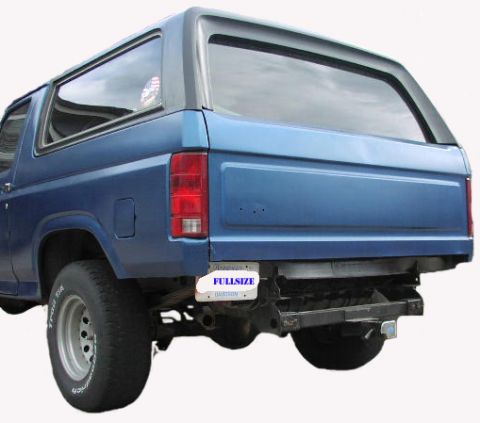 1981 Ford Bronco - Rear view of a blue SUV with a "FULLSIZE" license plate and tow hitch visible.