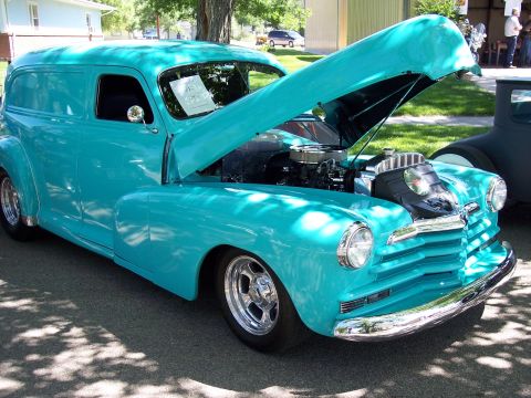 1972 Ford Ranchero - A turquoise sedan delivery is displayed with its hood open, revealing the engine bay.