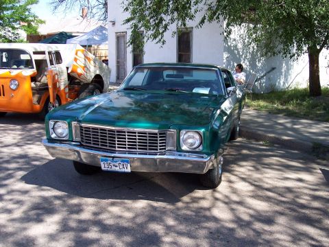 1972 Ford Ranchero - Green 1972 Ford Ranchero parked on street, with an orange custom van to its left.