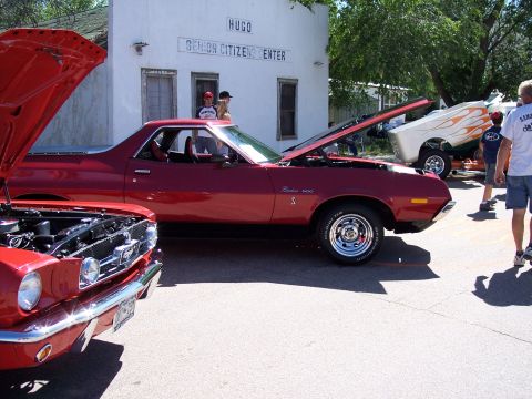 1972 Ford Ranchero - Two classic American cars, a 1972 Ford Ranchero and a Ford Mustang, displayed at an outdoor event.