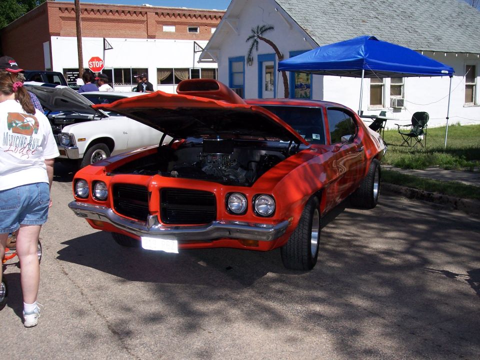 Orange 1972 Ford Ranchero front view with hood open, showing engine