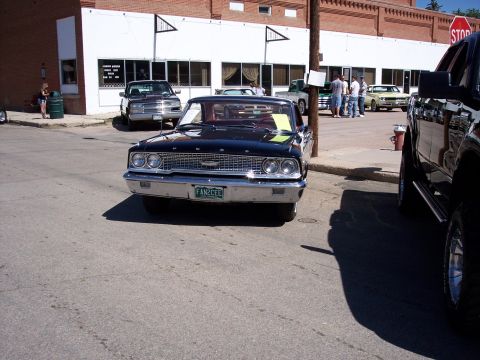 1972 Ford Ranchero - A black 1963 Ford Galaxie 500 is parked on a street in front of a building, with other vehicles nearby.