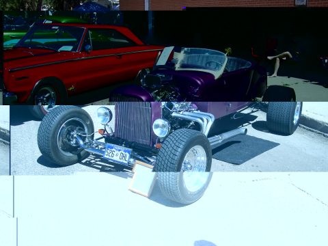 1972 Ford Ranchero - A purple hot rod is parked next to a red classic car.