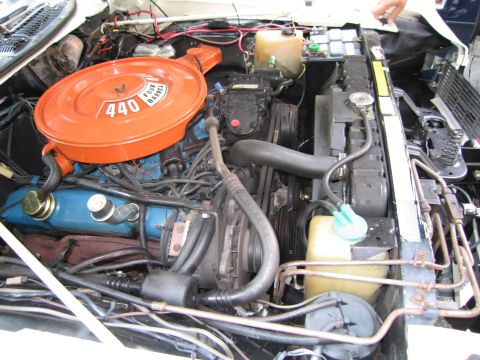 1991 Ford LTD Crown Victoria - engine bay of a classic car shows a large orange air cleaner stamped 440 over a V8 with a blue valve cover and hoses.