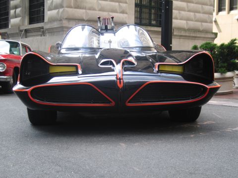 1991 Ford LTD Crown Victoria - Head-on front view of the black Batmobile with red trim, twin bubble canopies and mesh intake scoops.
