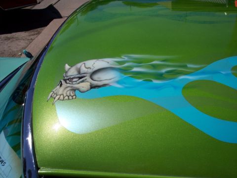 1972 Ford Ranchero - A custom airbrushed skull with flames adorns the hood of a green vehicle.