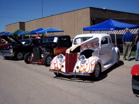 1972 Ford Ranchero - Several custom vehicles are displayed outdoors under tents at an event.