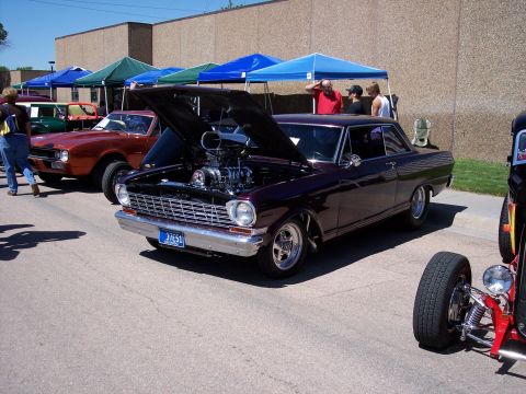 1972 Ford Ranchero - Custom 1966 Nova with exposed supercharger at a car show event.