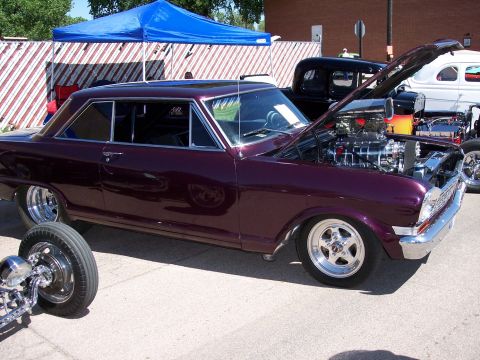 1972 Ford Ranchero - Customized 1966 Chevrolet Nova coupe with a prominent supercharged V8 engine on display at a car show.