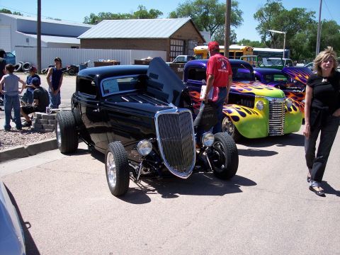 1972 Ford Ranchero - Several custom vehicles are on display at an outdoor event, with spectators milling about.