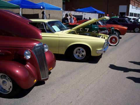 1972 Ford Ranchero - A variety of vehicles are displayed at an outdoor car show, with several hoods open to reveal engines.