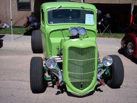 1972 Ford Ranchero - This modified truck features a distinctive grille and engine setup, seen next to another vehicle.