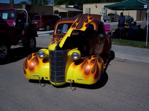 1972 Ford Ranchero - A custom hot rod truck with flame graphics is displayed outdoors, with its hood open.