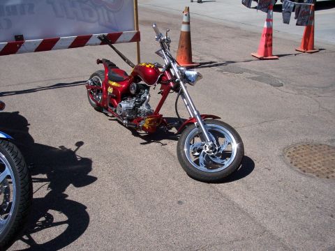 1972 Ford Ranchero - Custom chopper motorcycle with chrome wheels and red paint parked outdoors.