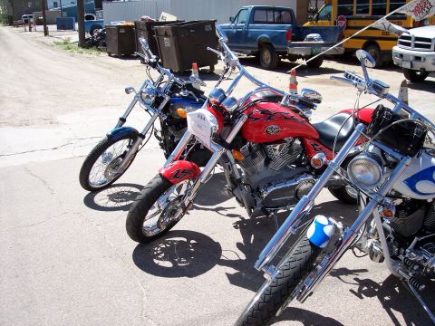1972 Ford Ranchero - Multiple motorcycles are parked in a row on a street, with other vehicles visible in the background.