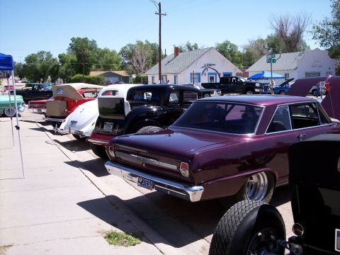 1972 Ford Ranchero - A row of vintage cars, including a purple 1966 Nova, are displayed at an outdoor event.
