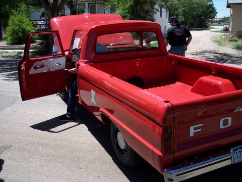 1972 Ford Ranchero - This red Ford pickup truck has its hood and driver's door open, revealing the interior.