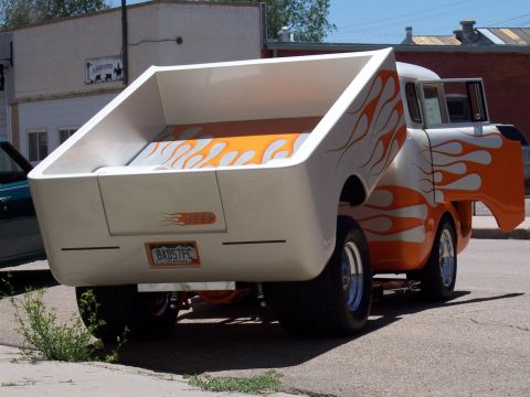 1972 Ford Ranchero - This custom pickup truck features flame graphics and a unique lifted bed design.