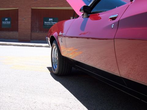 1972 Ford Ranchero - A pink muscle car with flames is parked outside a building with two USDA Service Center signs.