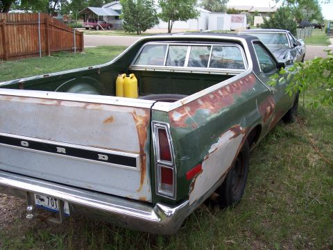 1972 Ford Ranchero - This 1972 Ford Ranchero shows significant wear and tear, with rust visible on the body panels and primer showing through.