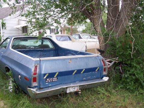 1972 Ford Ranchero - A blue 1972 Ford Ranchero is parked in a grassy area next to other vehicles and a tree.