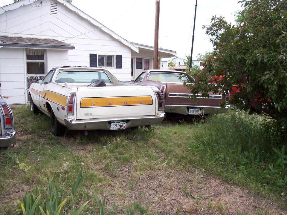 White 1972 Ford Ranchero with yellow stripe, rear view. License plate 697-TID
