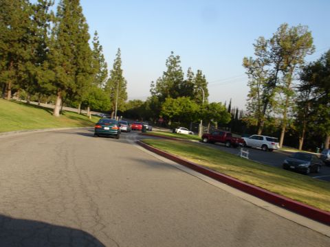 1993 Ford Taurus - A green sedan is seen driving on a road, with several other vehicles present in the background.