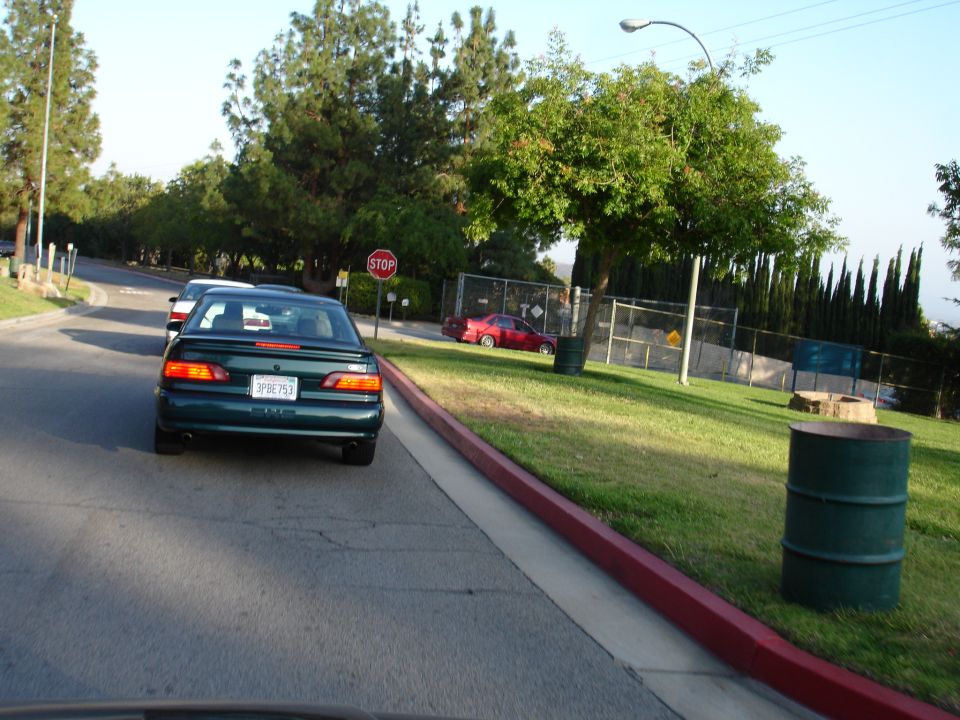 Green sedan from rear, license plate 3PBE753