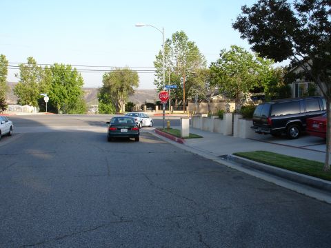 1993 Ford Taurus - A street scene with multiple vehicles, including a dark green sedan and a black SUV.