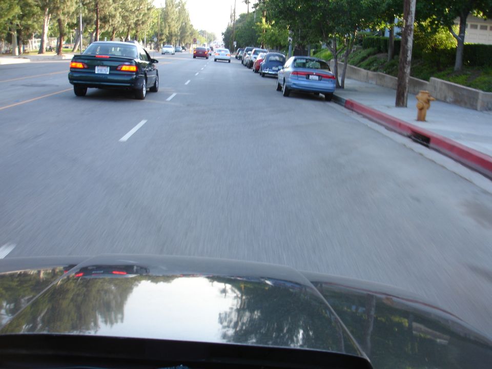 Dark green 1993 Ford Taurus sedan from rear view