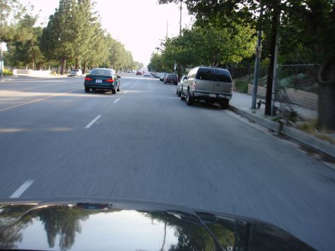 1993 Ford Taurus - Street view with several vehicles, including cars and an SUV, parked and in motion.