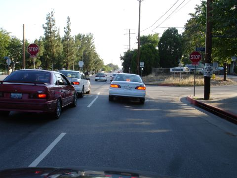 1993 Ford Taurus - Maroon 1993 Ford Taurus stopped in traffic on a sunny day.