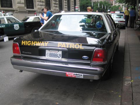 1991 Ford LTD Crown Victoria - rear of a black Ford Crown Victoria police car lettered 'HIGHWAY PATROL' with a California plate reading 888849 and a Don't Drink and Drive…