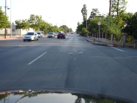 1993 Ford Taurus - Driving down a suburban street with other vehicles on the road.