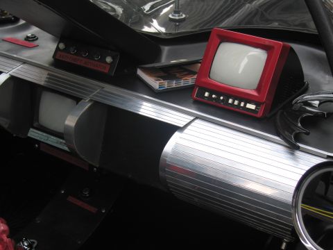 1991 Ford LTD Crown Victoria - close-up of a Batmobile replica console showing a red-bezel TV monitor, a smaller screen and a labeled 'Antitheft Activation' switch panel.