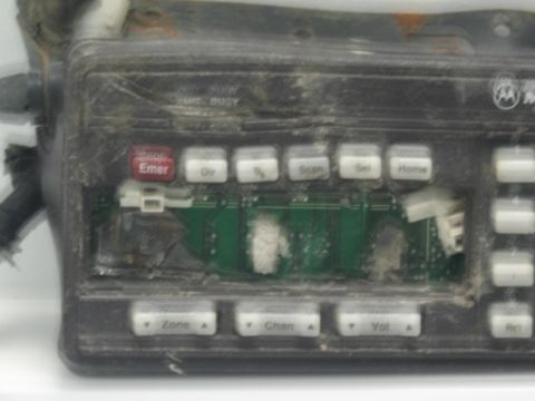 1991 Ford LTD Crown Victoria - extreme close-up of a grimy Motorola radio control face showing a red 'Emer' button and labeled keys for Scan, Set, Home, Zone, Chan and Vo…