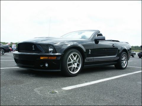 2001 Mercury Grand Marquis - Black convertible Ford Mustang GT500 with GT500 side stripe and Shelby Cobra emblem.