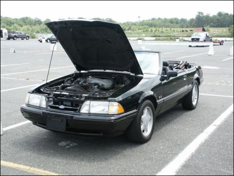 2001 Mercury Grand Marquis - Black convertible with hood open, engine visible, "5.0" badge on fender.