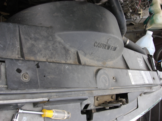 there are 3 10mm screw on the top of the fan shroud. i removed them.