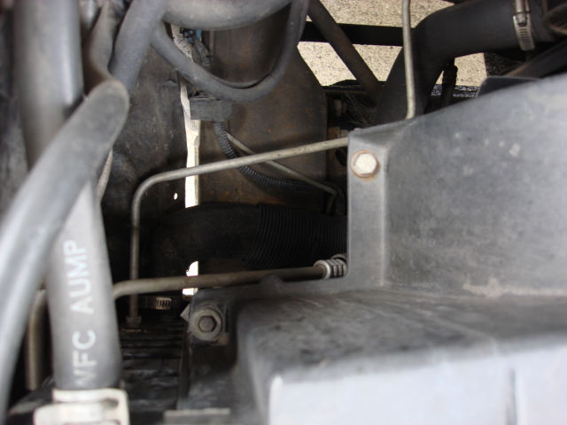there are 2 more screws on the side of the shroud.